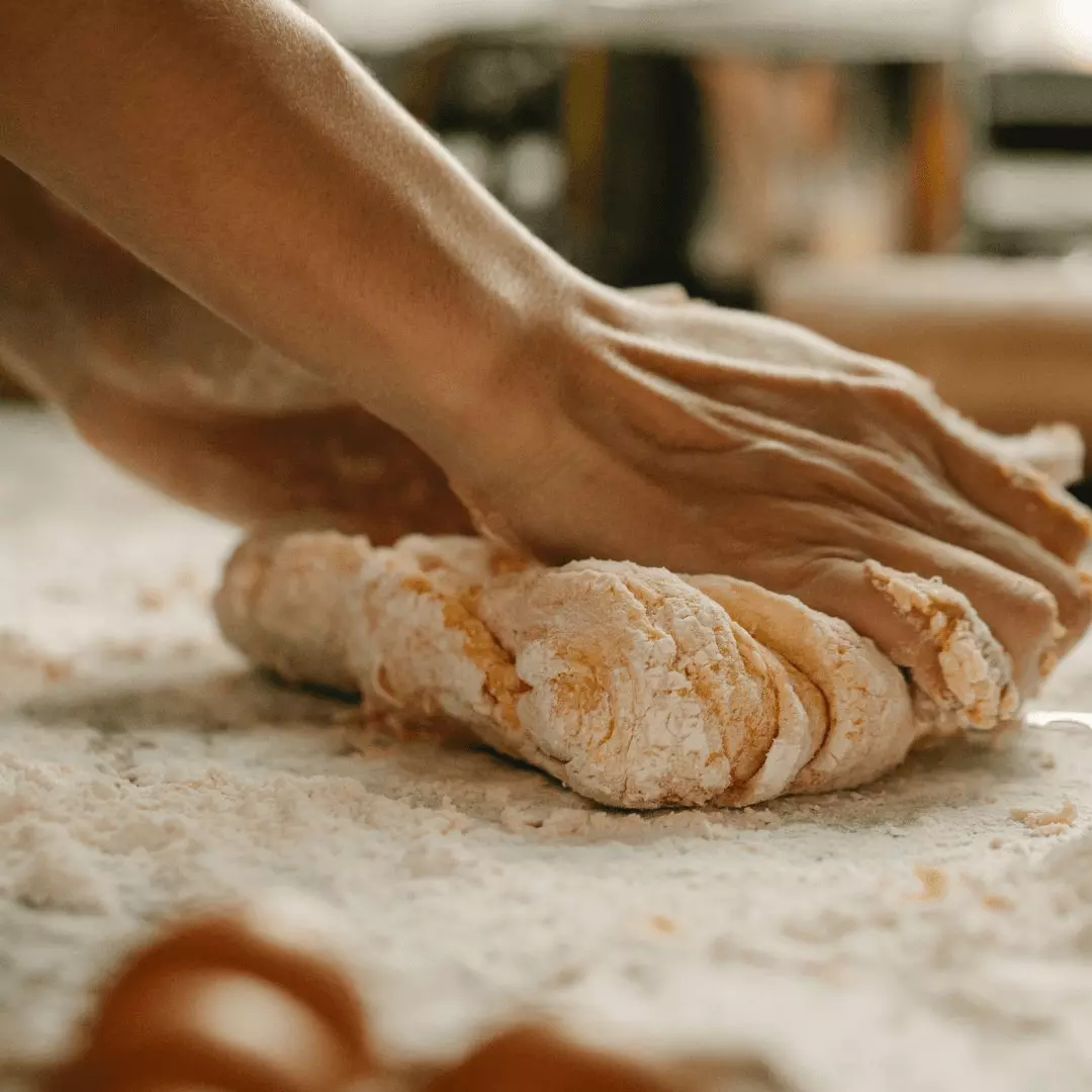 hands rolling out bread dough, a moment of everyday life and what it means to be spiritual